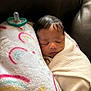 baby, sleeping, blanket, pillow, pacifier, rainbow, couch, leather, child, infant, rest, cozy, comfort, face, head, indoors, soft, peaceful, wrapped, toddler