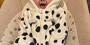 Areleigh is registered to the contest to win money with this photo: baby, baby_seat, carpet, child, clothing, colorful, cute, dalmatian_pattern, face, happy, hood, indoor, infant, onesie, plush, seat, smiling, star_pattern, toy, young_child