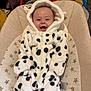 baby, baby_seat, carpet, child, clothing, colorful, cute, dalmatian_pattern, face, happy, hood, indoor, infant, onesie, plush, seat, smiling, star_pattern, toy, young_child