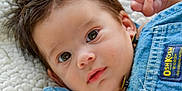 Braxton joined the competition — help win amazing prizes! baby, close_up, denim, infant, cute, face, eyes, expression, clothing, soft_texture, blanket, newborn, portrait, young_child, skin, hair, innocence, apparel, fabric, lying_down