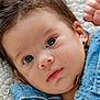 baby, close_up, denim, infant, cute, face, eyes, expression, clothing, soft_texture, blanket, newborn, portrait, young_child, skin, hair, innocence, apparel, fabric, lying_down