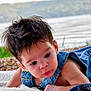 baby, child, denim_overalls, blanket, outdoor, lake, water, grass, nature, portrait, curious, face, infant, toddler, cute, expression, young, person, relaxing, scenery