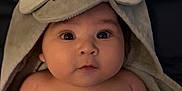 Alessandro is registered to the contest to win money with this photo: baby, infant, towel, elephant_hood, cute, face, portrait, child, skin, blanket, expression, eyes, headwear, indoor, person, newborn, soft, warm, adorable, curious