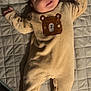 Alessandro is registered to the contest to win money with this photo: baby, infant, onesie, bear_design, quilted_mat, lying_down, cute, smiling, child, soft_fabric, indoors, face, hands_up, footed_pajamas, sleepwear, adorable, young_child, portrait, cozy, expression