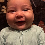 Alessandro joined the competition — help win amazing prizes! baby, smile, onesie, infant, child, face, happy, cheeks, portrait, clothing, fabric, zipper, lying_down, blanket, pattern, floral, soft, cute, head, skin
