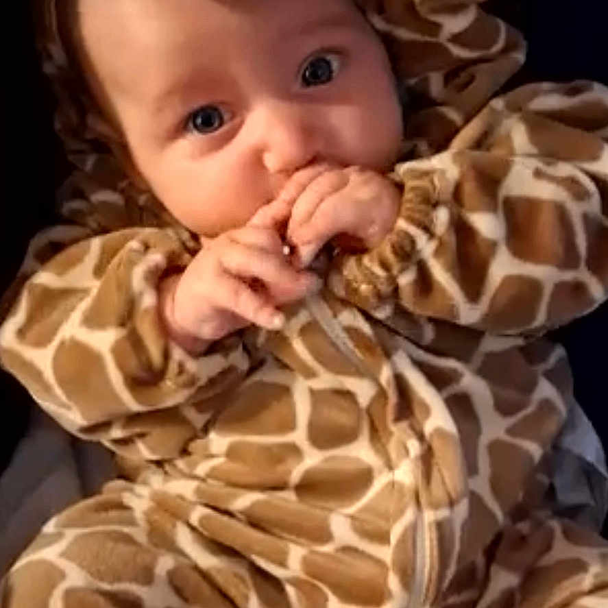 Lydia Rose joined the competition — help win amazing prizes! adorable, baby, child, clothing, costume, cozy, cute, expression, eyes, face, giraffe_onesie, hands, indoor, infant, looking, plush, portrait, sitting, soft_fabric, young