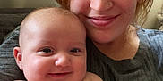 Lydia Rose is registered to the contest to win money with this photo: baby, woman, smiling, portrait, indoor, face, skin, happy, person, child, diaper, holding, arm, hair, casual_clothing, couch, closeup, cheerful, parent, family