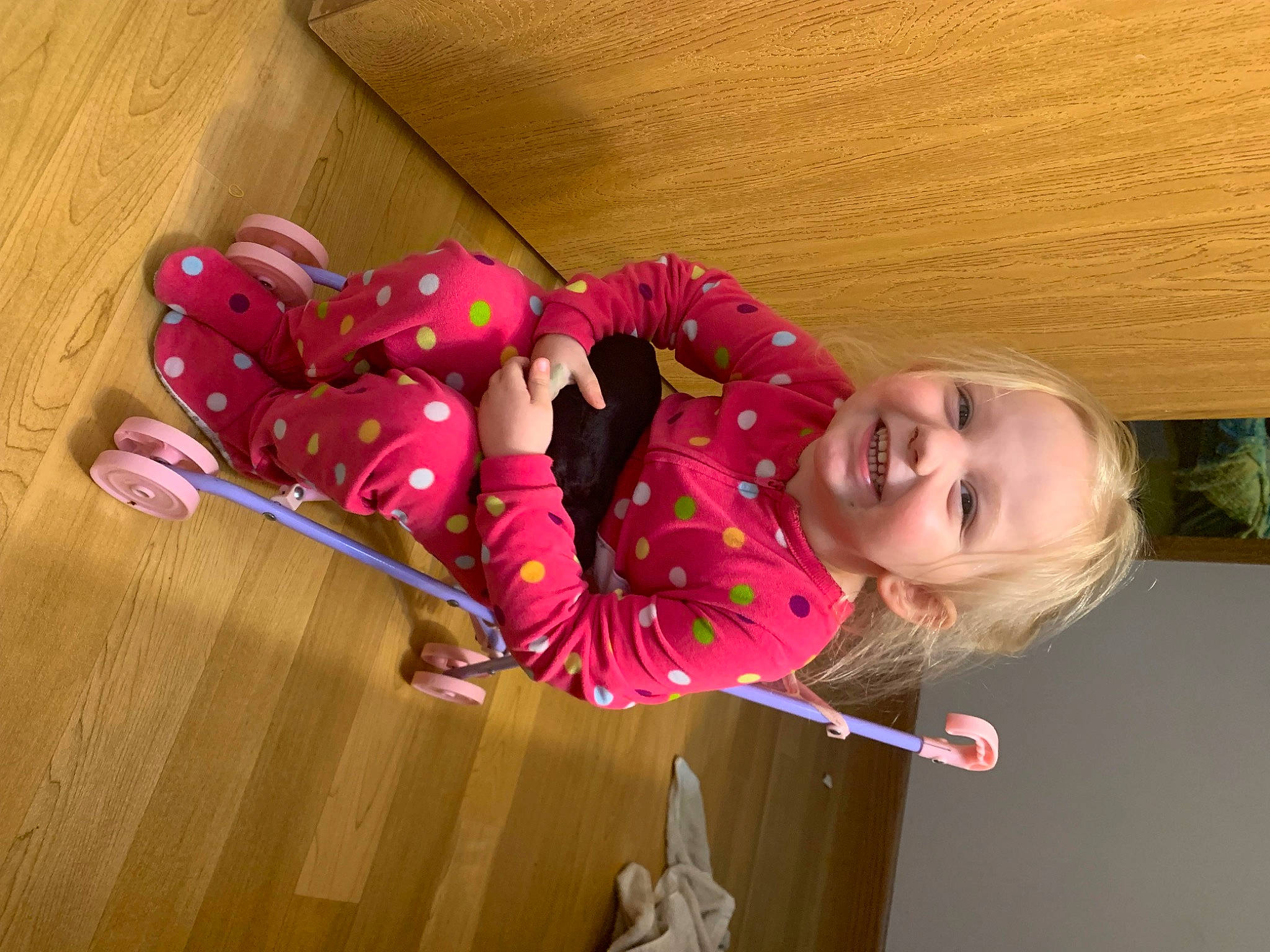 Sadie is registered to the contest to win money with this photo: baby, baby_toddler_clothing, carmine, child, flooring, foot, fun, happy, hardwood, joy, magenta, pattern, person, pink, play, room, skin, sleeve, smile, toddler