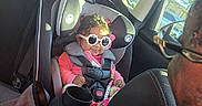 Alaiah joined the competition — help win amazing prizes! adult, baby, car_interior, car_seat, child, clothing, cute, glasses, hair, headrest, person, safety, seat, seatbelt, smile, sunglasses, sunlight, travel, vehicle, window