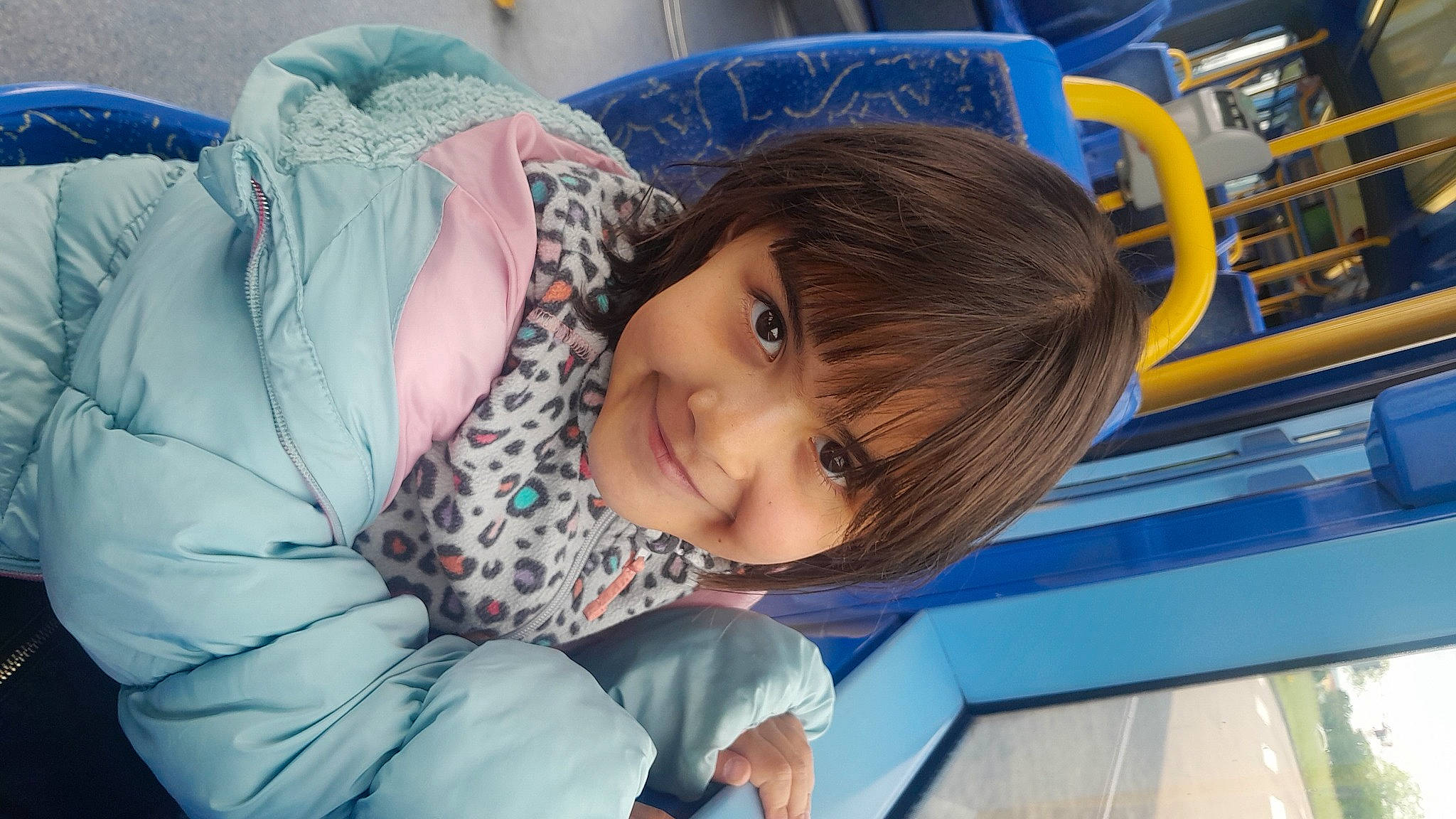 Angelina participe au concours pour gagner de l'argent avec cette photo : azure, baby, baby_toddler_clothing, black_hair, blue, chair, cheek, child, chin, comfort, electric_blue, fun, happy, joy, leisure, person, sitting, smile, toddler, travel