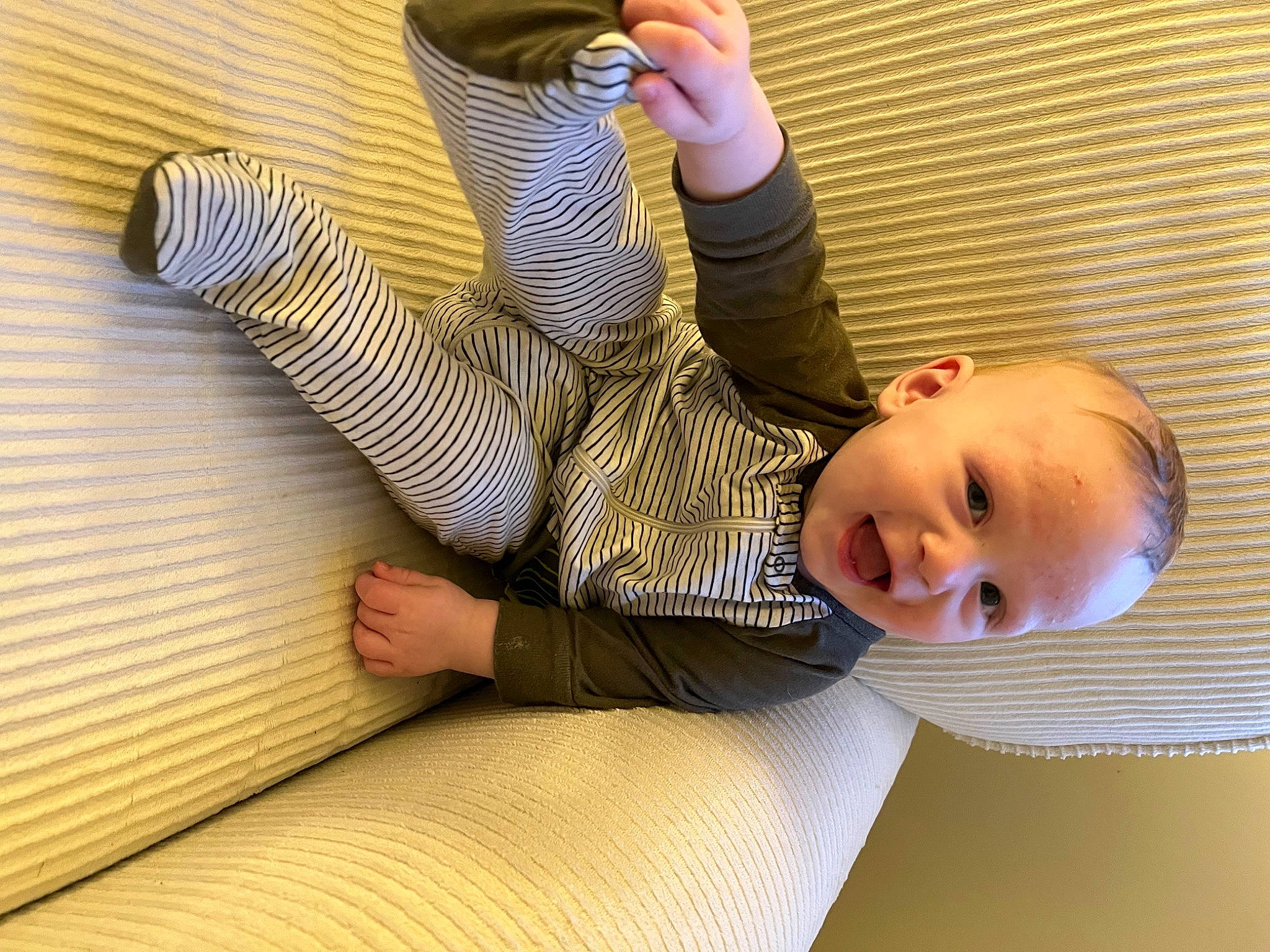 Cortez Jr is registered to the contest to win money with this photo: child, comfort, elbow, finger, flooring, foot, gesture, happy, human_leg, joint, knee, leg, leisure, nail, person, smile, thigh, thumb, toddler, wood