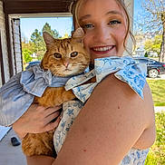 Miley joined the competition — help win amazing prizes! woman, cat, outdoor, smiling, blue_sky, trees, porch, dress, orange_cat, pet, happy, holding, sunlight, nature, greenery, face, closeup, daylight, fashion, animal