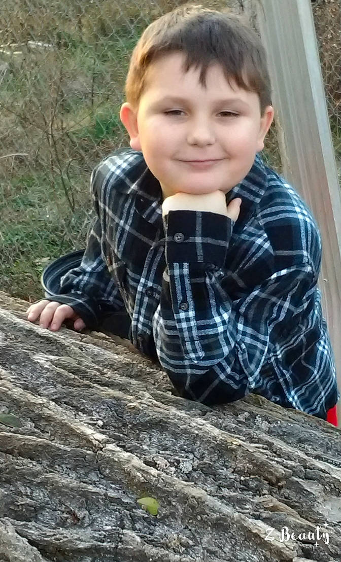 Isiah is registered to the contest to win money with this photo: cheek, child, child_model, design, fawn, grass, joy, pattern, person, photography, plaid, plant, play, sitting, smile, soil, tartan, toddler, wood