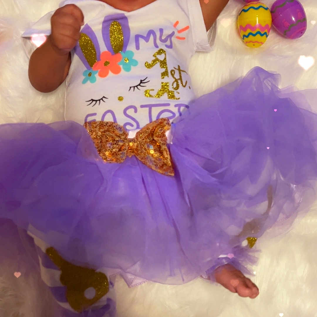 Amirez joined the competition — help win amazing prizes! baby, bow, celebration, child, cute, decorations, easter_eggs, festive, fluffy_surface, headband, hearts_overlay, holiday, infant, lying_down, onesie, plush_carrots, purple, smiling, soft_texture, tutu