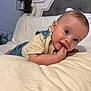 Cash is registered to the contest to win money with this photo: baby, infant, bed, bedding, face, hand, eyes, clothing, headboard, room, lamp, wall, comfort, cute, portrait, child, indoors, expression, sleepwear, soft