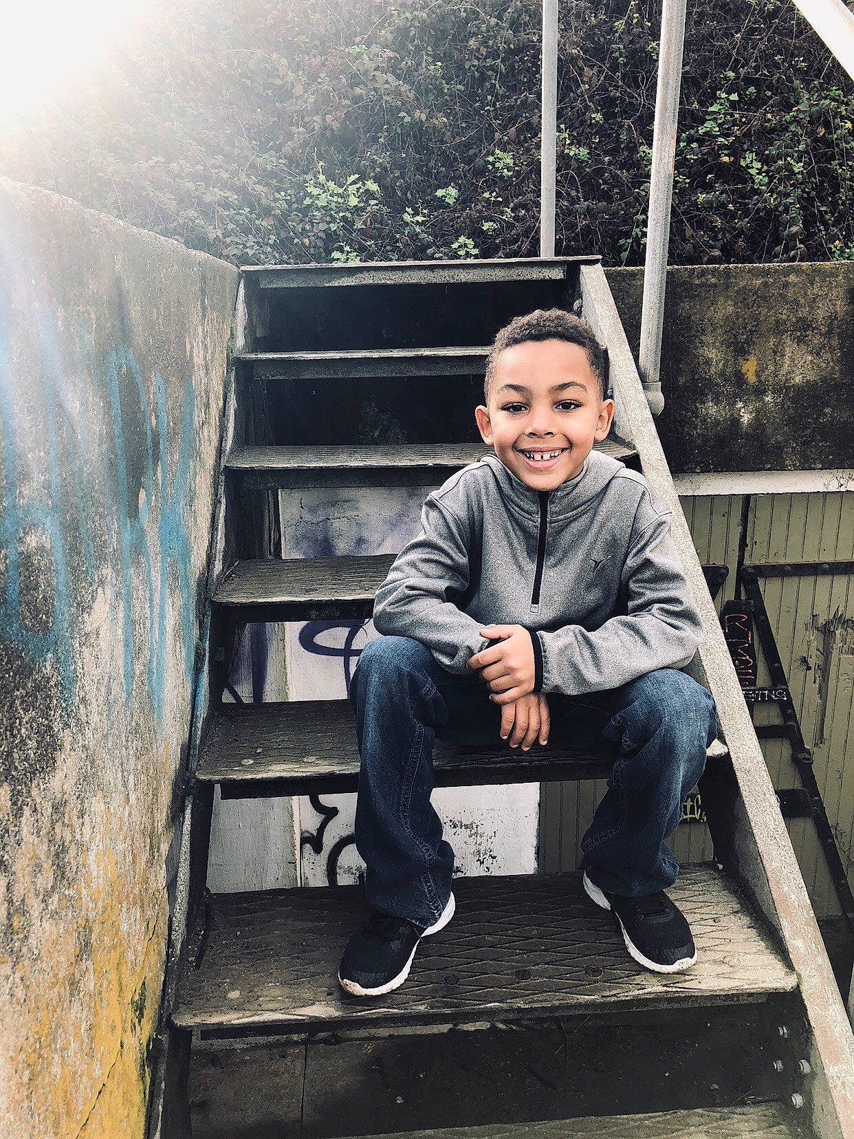 Jalen is registered to the contest to win money with this photo: child, denim, footwear, house, jeans, joy, male, person, photo_shoot, photography, shoe, sitting, smile, stairs, t_shirt