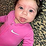 Alora joined the competition — help win amazing prizes! baby, child, pink_clothing, tongue_out, curly_hair, hair_ties, leopard_print, blanket, lying_down, cute, playful, portrait, indoors, infant, face, person, smiling, closeup, young_child, happy