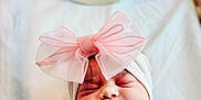 Alora joined the competition — help win amazing prizes! newborn, baby, smiling, swaddle, pink_bow, headwear, blanket, face, infant, sleepy, cute, portrait, soft_lighting, hospital, bed, celebration, flower_pattern, lying_down, peaceful, closeup