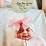 newborn, baby, smiling, swaddle, pink_bow, headwear, blanket, face, infant, sleepy, cute, portrait, soft_lighting, hospital, bed, celebration, flower_pattern, lying_down, peaceful, closeup