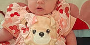 Aurora is registered to the contest to win money with this photo: baby, infant, toddler, dress, floral, pillow, cute, face, person, smiling, child, apparel, pattern, fabric, soft, indoors, skin, head, hand, lying