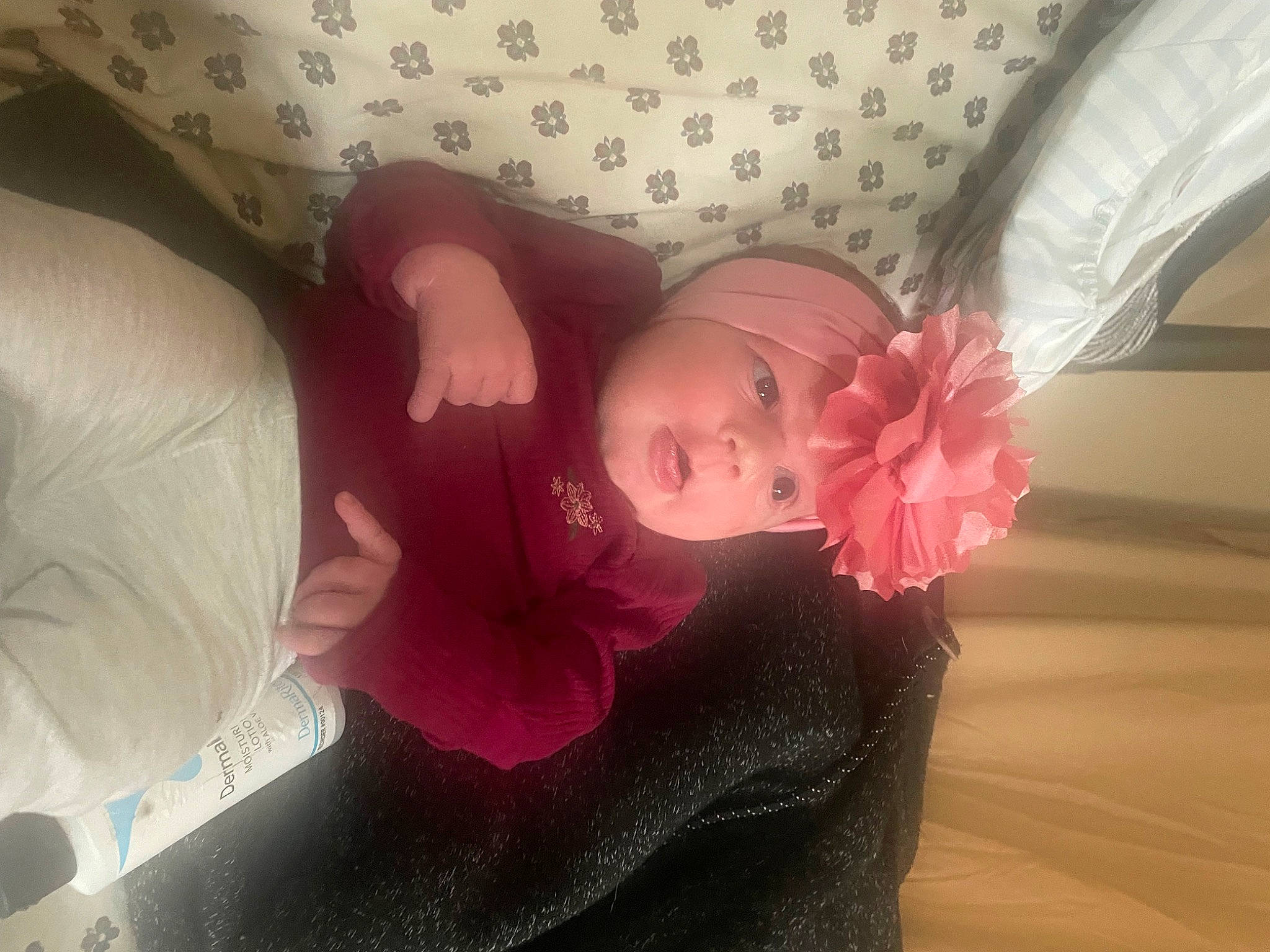 Letty is registered to the contest to win money with this photo: abdomen, baby, chest, child, comfort, elbow, eyelash, fashion_accessory, hand, head, headgear, headwear, human_body, human_leg, lip, magenta, person, petal, pink, room