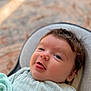 baby, infant, portrait, smiling, tongue_out, eyes, hair, blanket, onesie, bouncer, seat, closeup, soft_light, indoor, cozy, happy, cheeks, skin, blanket_texture, baby_bed