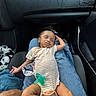 Terrion joined the competition — help win amazing prizes! baby, sleeping, infant, striped_onesie, pacifier, lap, person, car_interior, seat, clothing, hand, blue_jeans, black_leather, comfort, relaxation, child, cute, peaceful, indoor, transportation