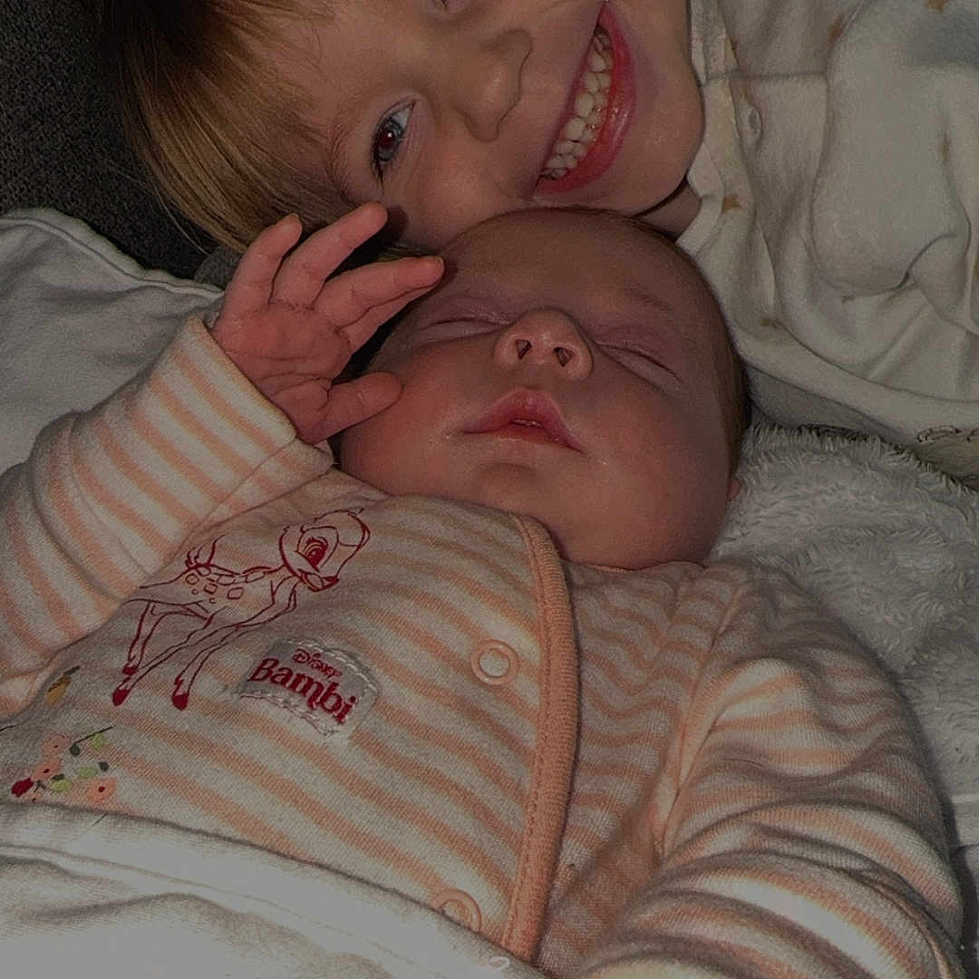 Sofia And Ava joined the competition — help win amazing prizes! baby, bambi_design, blanket, child, closeup, cuddling, cute, family, happy, indoor, infant, onesie, portrait, relaxing, sleeping, smiling, soft_lighting, striped_clothing, toddler, two_children