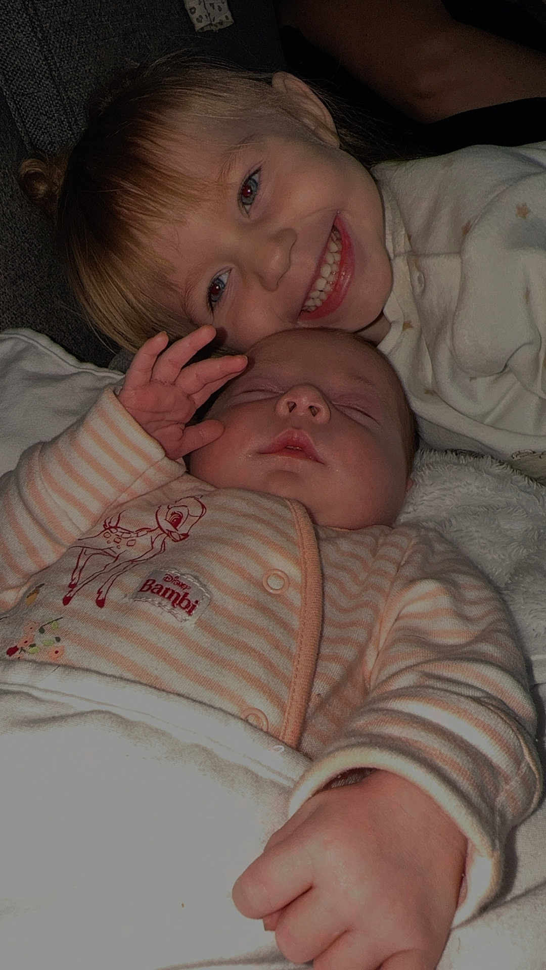 Sofia And Ava joined the competition — help win amazing prizes! baby, toddler, child, sleeping, smiling, cuddling, blanket, onesie, striped_clothing, bambi_design, cute, indoor, closeup, family, happy, infant, soft_lighting, relaxing, two_children, portrait