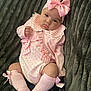 Remi joined the competition — help win amazing prizes! baby, infant, pink_clothing, bow, headband, socks, blanket, cute, portrait, child, soft_texture, cozy, knitwear, striped_collar, polka_dots, ruffles, lying_down, indoor, adorable, young_child
