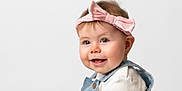 Elizabeth is registered to the contest to win money with this photo: baby, cheeks, child, clothing, cute, denim, eyes, face, happy, headband, infant, innocence, overalls, person, pink, portrait, smile, studio, white_background, young