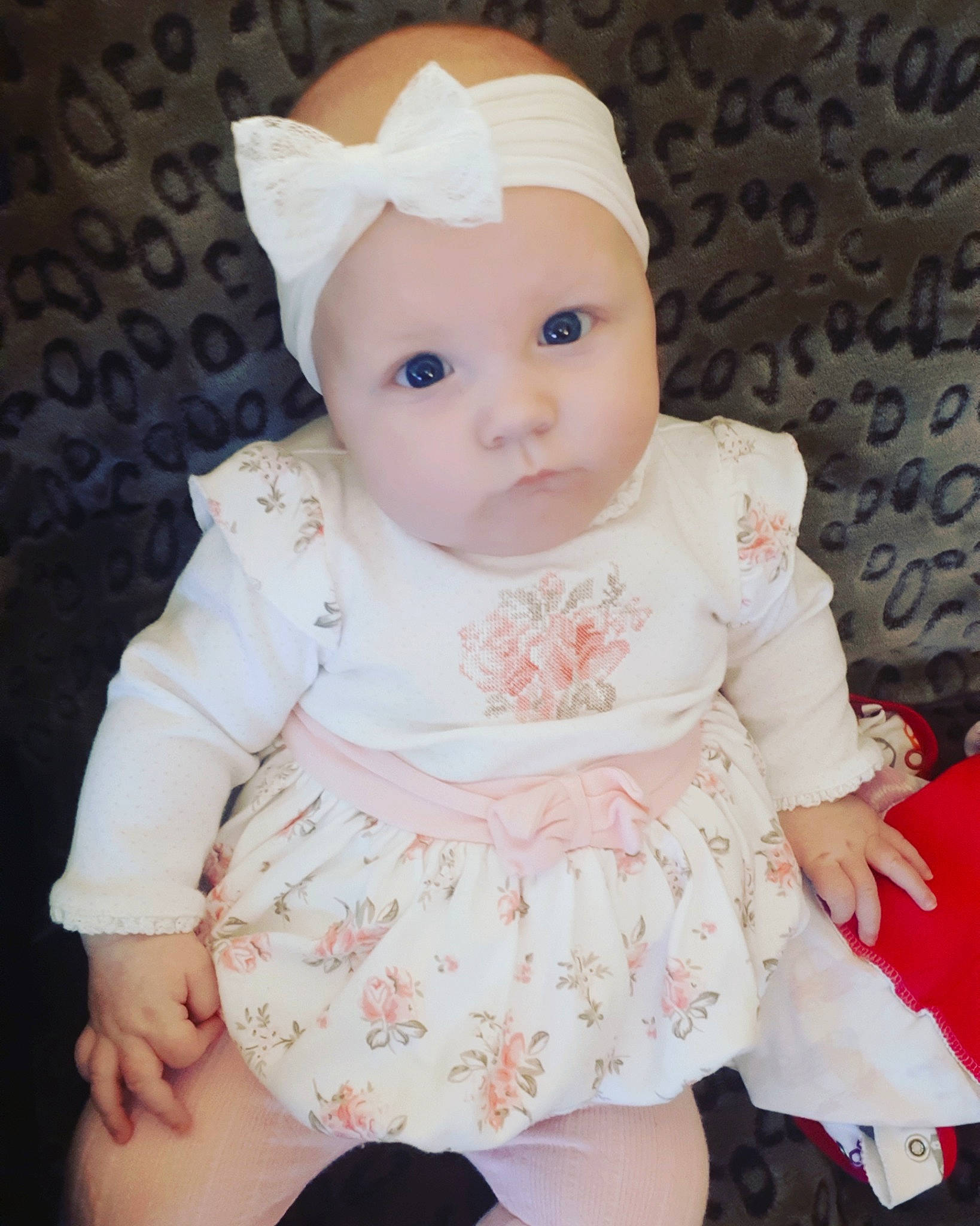 Noélie participe au concours pour gagner de l'argent avec cette photo : baby, cheek, child, doll, dress, head, headgear, headwear, person, pink, sitting, skin, toddler, toy