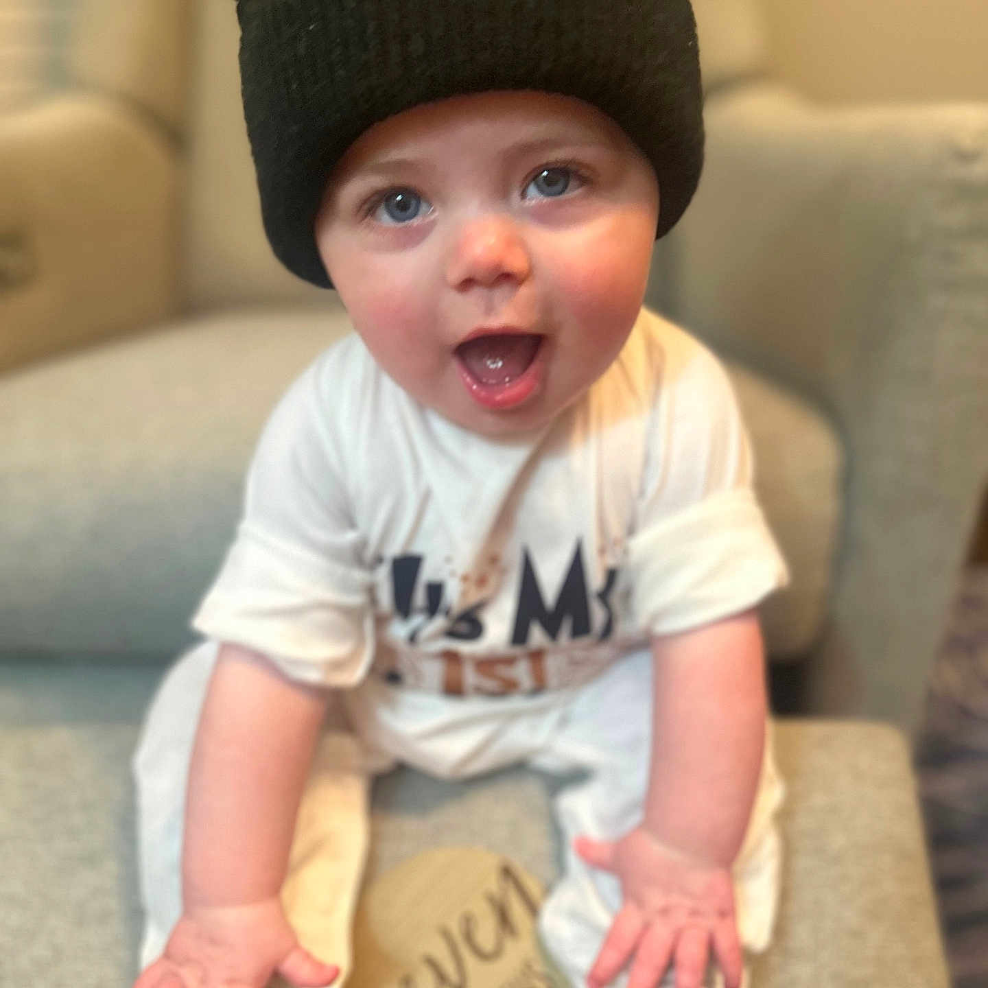 Rhett joined the competition — help win amazing prizes! baby, black_hat, blue_eyes, chair, child, clothing, cushion, cute, happy, hat, indoor, infant, open_mouth, person, portrait, seven_months, sitting, smiling, sock, wooden_sign