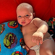 August joined the competition — help win amazing prizes! baby, blanket, blue, cartoon, child, closeup, cute, diaper, expression, green, indoor, infant, ninja_turtles, playful, portrait, reaching, red, skin, soft, towel