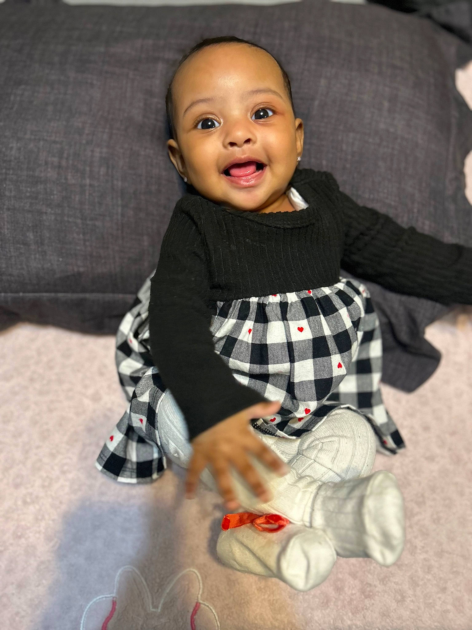 Sayari joined the competition — help win amazing prizes! baby_toddler_clothing, cheek, child, collar, doll, eye, flooring, formal_wear, gesture, happy, head, human_body, pattern, person, plaid, sitting, sleeve, smile, sock, tartan