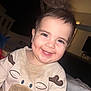 baby, toddler, smiling, portrait, indoor, onesie, moose, animal_applique, messy_face, teeth, earrings, bedroom, blanket, soft_lighting, close_up, happy, infant, spiky_hair, flash, cute