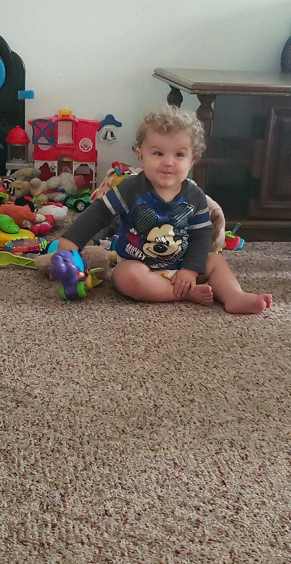 Fletcher is registered to the contest to win money with this photo: baby, child, floor, flooring, fun, leg, person, play, sitting, smile, toddler, toy, vacation