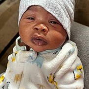 Sire joined the competition — help win amazing prizes! baby, infant, onesie, hat, sleepy, face, cozy, indoor, couch, child, person, young, cute, apparel, portrait, warm, expression, newborn, furniture, soft