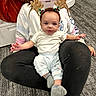Mason joined the competition — help win amazing prizes! baby, child, person, reindeer_antlers, headband, white_shirt, leggings, socks, carpet, floor, indoor, smile, face, holiday, festive, cute, seated, lap, carpeted_floor, happy