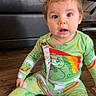 Willow is registered to the contest to win money with this photo: baby, bright_colors, child, clip, curious_expression, cute, face, floor, furniture, green_clothing, indoor, living_room, long_sleeves, pacifier, pajamas, person, rainbow, sitting, wooden_floor, young_child