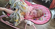 Willow joined the competition — help win amazing prizes! baby, blanket, child, clothing, comfort, cozy, floor, furniture, household, indoor, infant, owl_pattern, pacifier, pink, resting, rocker, sleeping, soft, toy_pattern, wooden_floor