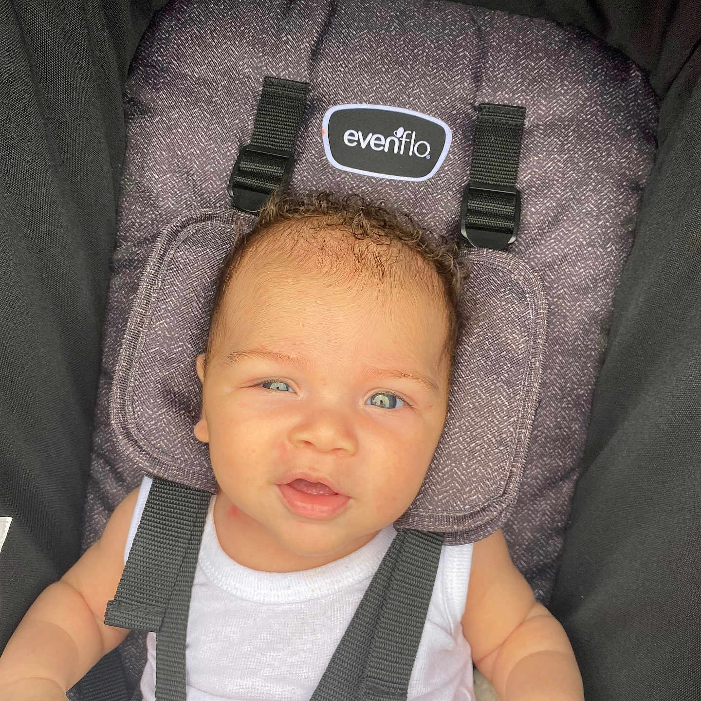 Ladarius is registered to the contest to win money with this photo: baby, baby_clothing, blue_eyes, car_seat, child, comfort, curly_hair, cute, expression, face, indoors, infant, person, portrait, safety, seat, skin, straps, white_tank_top, young_child
