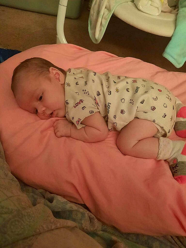 Mazikeen is registered to the contest to win money with this photo: arm, baby, baby_sleeping, baby_toddler_clothing, cheek, child, chin, comfort, finger, foot, head, human_body, human_leg, linens, mouth, person, pink, room, skin, sleeve