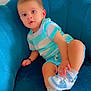 toddler, child, blue_chair, striped_shirt, shorts, sneakers, white_socks, indoor, portrait, curious, cute, comfortable, plush, seated, young_child, baby, casual_clothing, small_hand, expression, relaxed