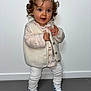 toddler, child, curly_hair, blue_eyes, white_vest, pink_shirt, white_leggings, sneakers, standing, indoor, floor, wall, cute, fashion, portrait, person, young_child, happy, smiling, clothing
