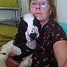 Bandit a rejoint le concours — aidez-le/la à gagner de superbes lots ! black_and_white_dog, casual, cherry_pattern, cushion, dog, expression, eyewear, face, furniture, glasses, holding, home, indoor, pet, portrait, relaxed, seated, shelf, shirt, woman
