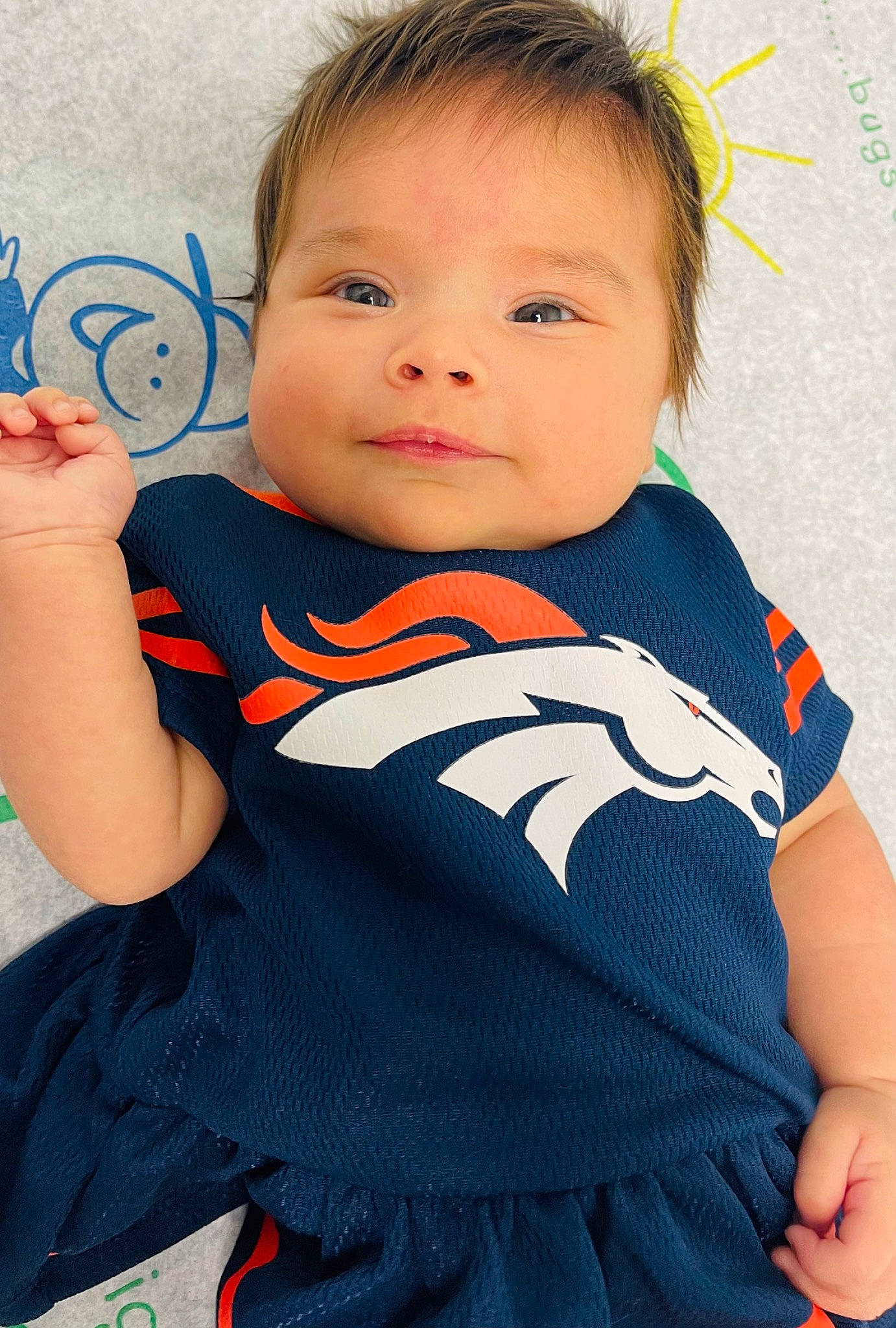 Kora is registered to the contest to win money with this photo: arm, azure, baby_toddler_clothing, cheek, cool, eye, finger, happy, head, iris, joint, neck, person, product, shoulder, skin, sleeve, smile, standing, t_shirt