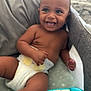 baby, diaper, smile, toy, piano, infant, child, happy, playtime, indoors, couch, blanket, cute, face, skin, hand, legs, sitting, joy, young