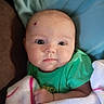 baby, infant, blanket, green_shirt, face, head, eyes, skin, child, indoors, portrait, cute, soft, cozy, newborn, expression, person, clothing, wrapped, resting
