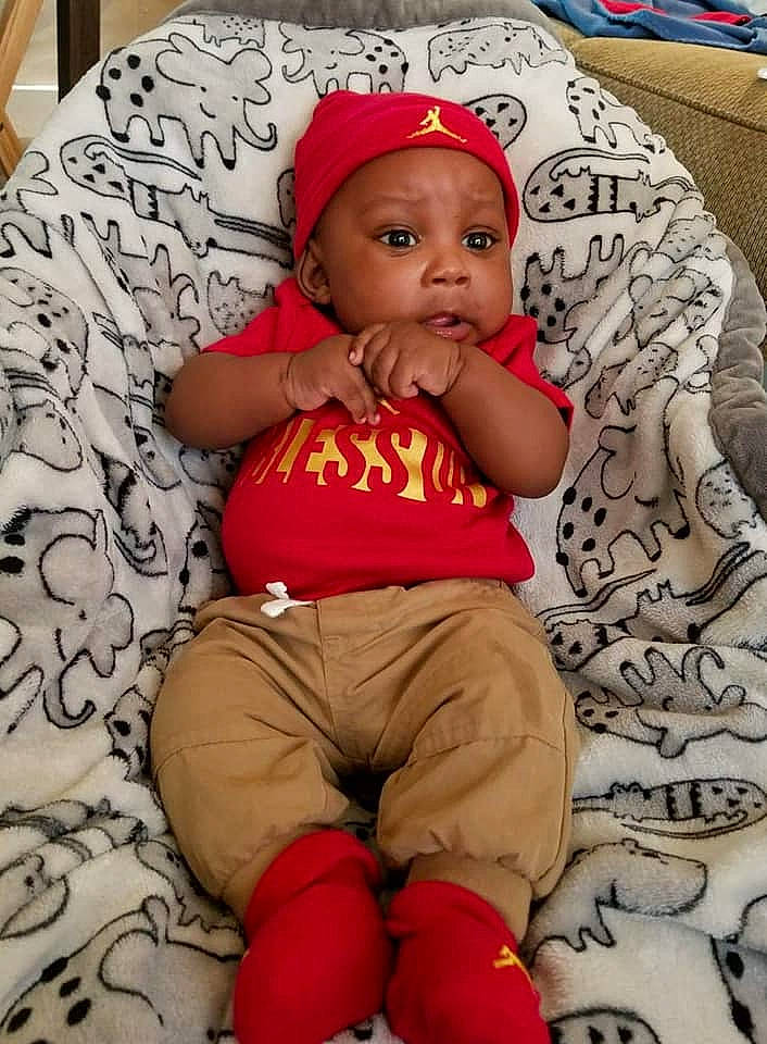 Jamar is registered to the contest to win money with this photo: child, day, headgear, infant, organ, person, product, red, sitting, skin, toddler